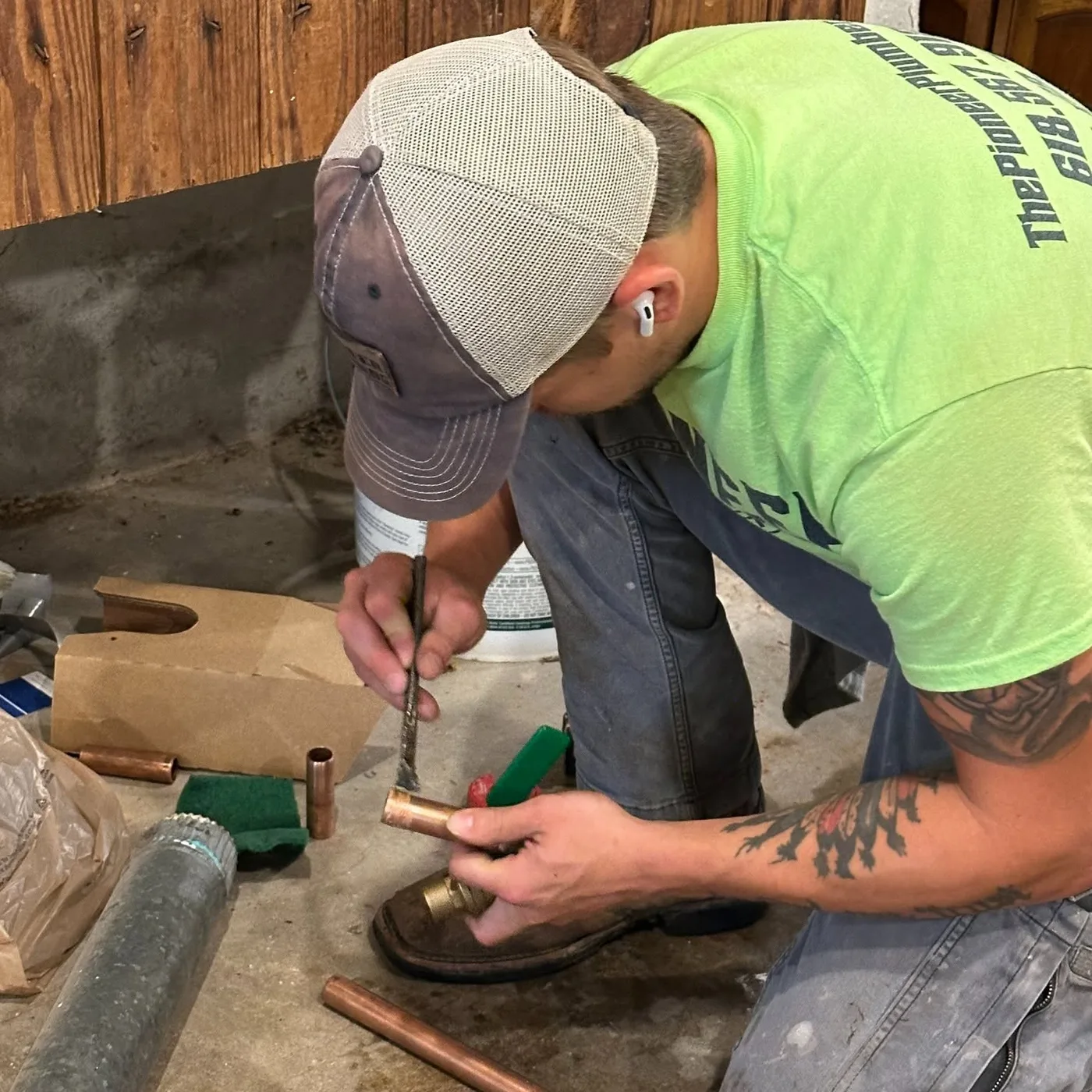 Pioneer technician preparing copper during a water-heater installation